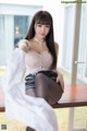 A woman sitting on top of a wooden table.