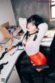 A woman sitting at a desk in an office.