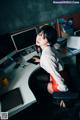 A woman sitting at a desk in front of a computer.