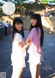 A couple of young women standing next to each other.