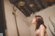 A woman standing in a bathroom next to a shower.