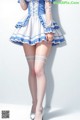 a woman in a blue and white dress and stockings