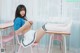 A woman sitting at a desk with her legs crossed.